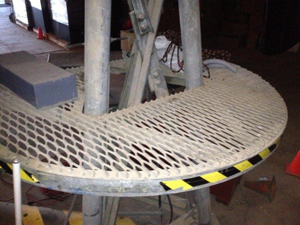 2 Steel grating catwalk with a perforated plate section marked by yellow and black safety tape